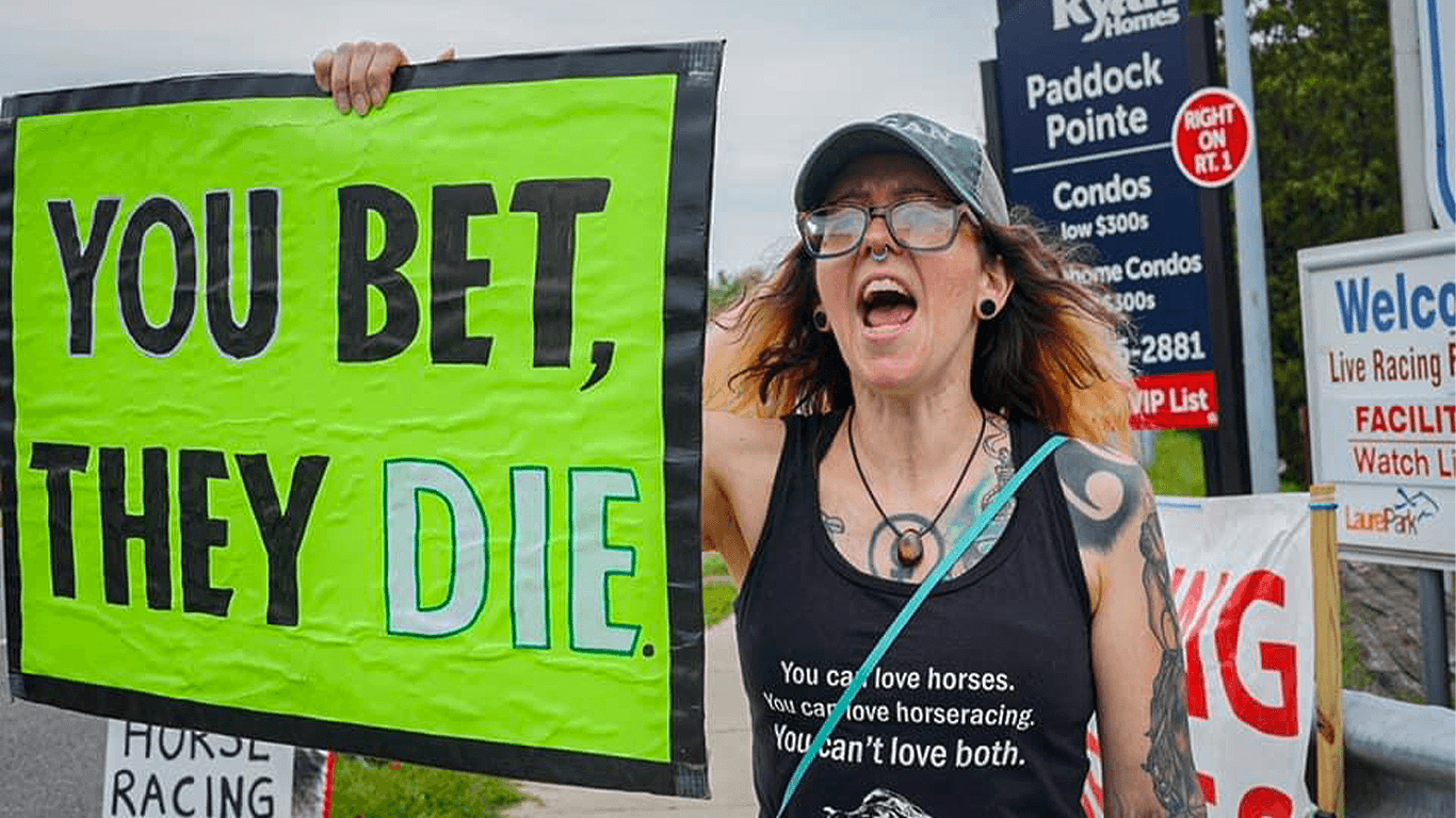 angry female activist holding sign that reads 'you bet, they die'
