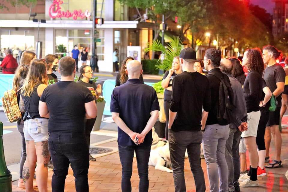 Group of people huddling in a circle after an event